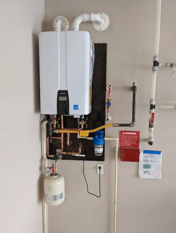 Professional plumber installing copper piping in a Mission home